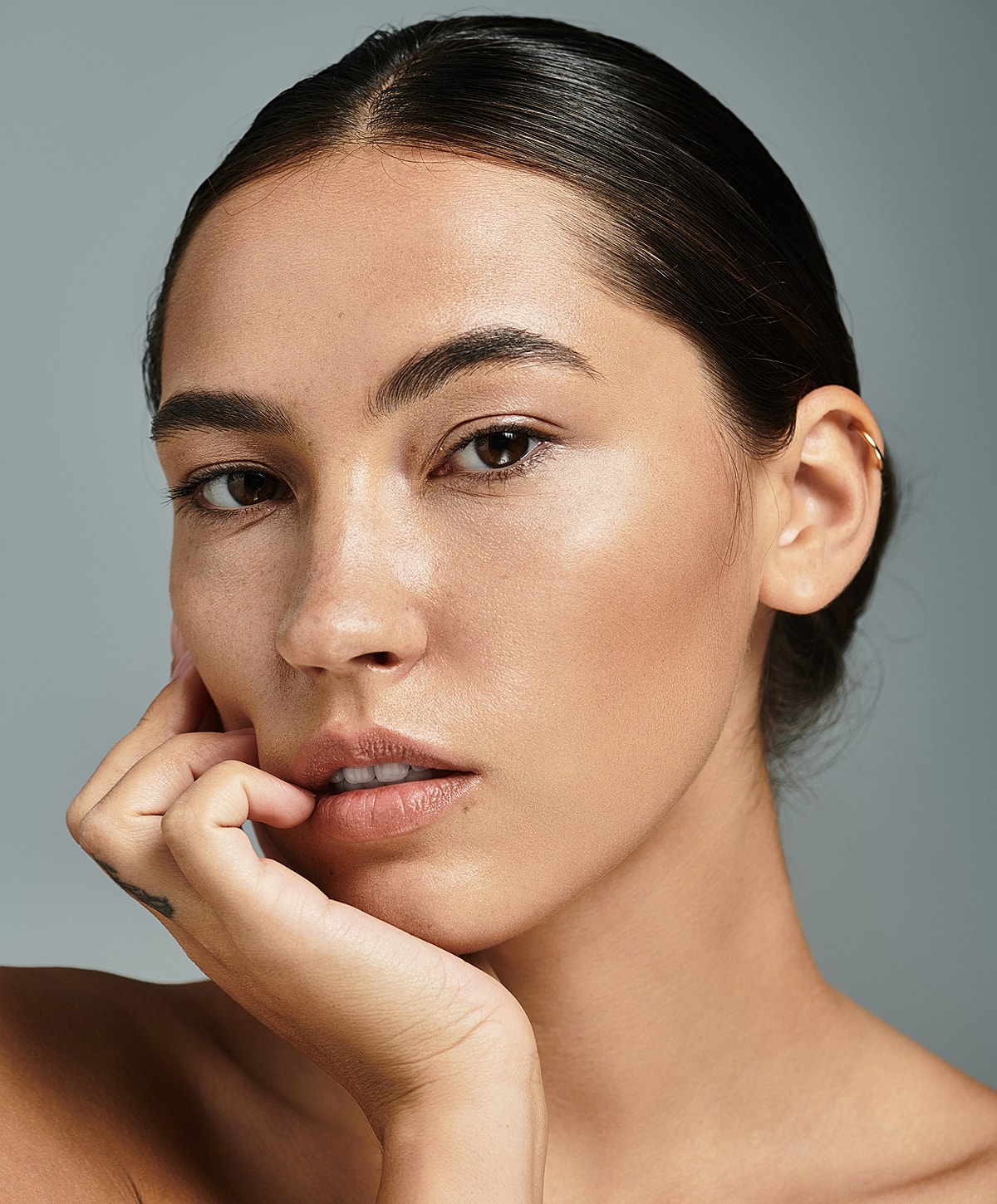 Close-up portrait of a woman with clear skin.